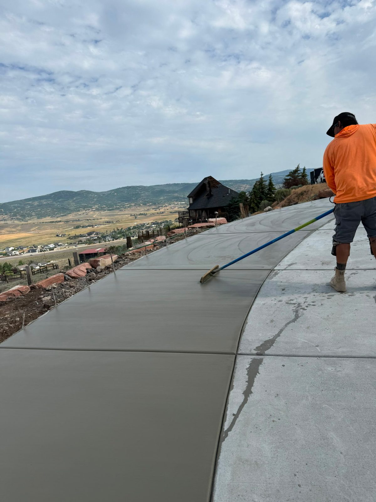 Broom finishing a hillside driveway