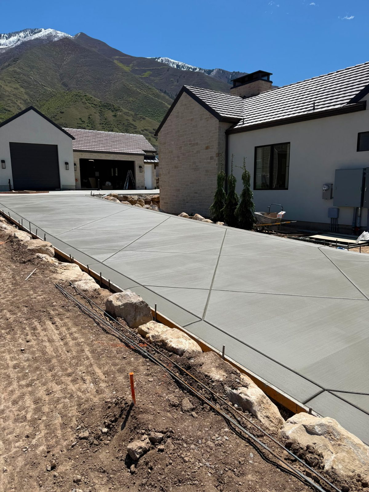 Diamond-scored driveway beside a home